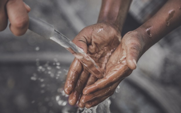 water from a hose rinsing hands